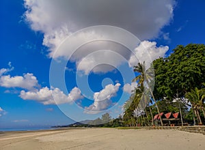 Beach on the tropical island. Clear blue water, sand and palm trees. Beautiful vacation spot, treatment and aquatics.