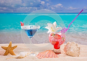 Beach tropical red and blue cocktail on caribbean white sand