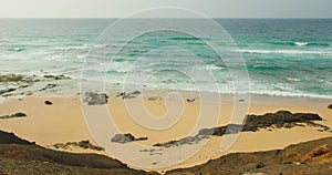 Beach with turquoise water on Fuerteventura island, Spain, Canaries. Sand paradise seashore, ocean texture, view of sea