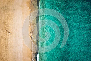 Beach with turquoise water on Fuerteventura island, Spain, Canary islands. Aerial view of sand beach, ocean texture background,