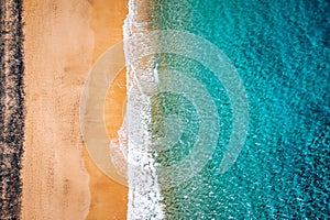 Beach with turquoise water on Fuerteventura island, Spain, Canary islands. Aerial view of sand beach, ocean texture background,