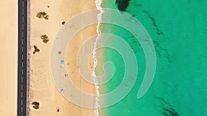 Beach with turquoise water on Fuerteventura island, Spain, Canary islands. Aerial view of sand beach, ocean texture background