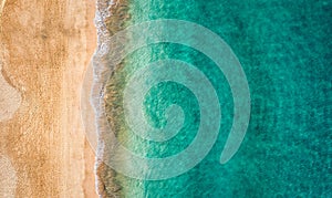 Beach with turquoise water on Fuerteventura island, Spain, Canary islands. Aerial view of sand beach, ocean texture background,