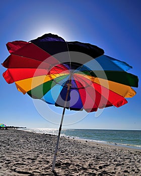 Bright colored beach umbrella on a sunny beach day.