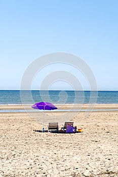 Beach with umbrella and chairs