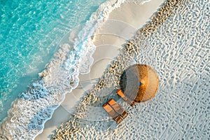 Beach umbrella and chairs. White sand and blue crystal clear sea for luxury summer vacation holiday