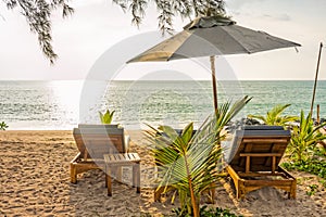 Beach umbrella and sunbath seats on Pak Weep beach in the evening