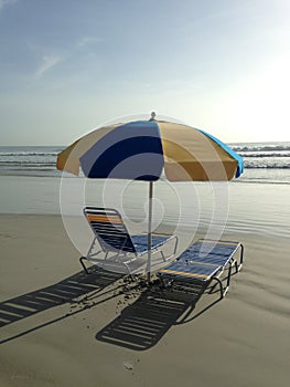 Beach Umbrella and Two Chairs/Beds on Daytona Beach, Florida.