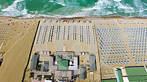 Beach umbrellas and chairs on the beach. Aerial bird eye view