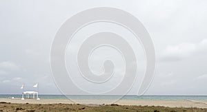 Beach with umbrellas and chairs in cloudy weather