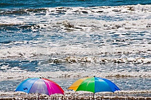 Beach Umbrellas and Crashing Ocean Waves