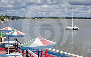 Beach umbrellas on deck and boat at river