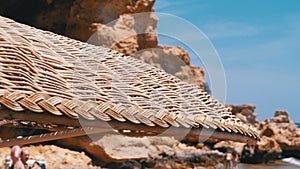 Beach with Umbrellas in Egypt on Red Sea. Sunny Resort on Rocky Coast.