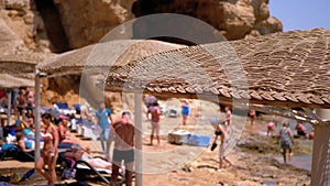 Beach with Umbrellas in Egypt on Red Sea. Sunny Resort on Rocky Coast of Egypt