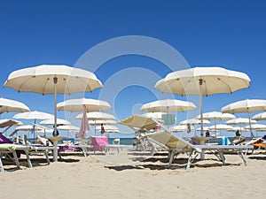 Beach umbrellas, gazebos and sun beds at Italian sandy beaches. Adriatic coast. Emilia Romagna, Itsly