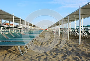 Beach umbrellas, gazebos and sun beds at Italian sandy beaches. Adriatic coast. Emilia Romagna region