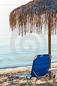 Beach umbrellas and loungers on a beach at an idyllic tropical resort