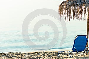 Beach umbrellas and loungers on a beach at an idyllic tropical resort for a summer