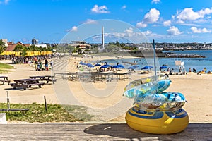 Beach umbrellas and palm trees on the Sunset beach in Chatan City in the American Village of Okinawa island in Japan