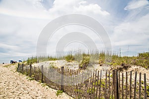 Beach Umbrellas Past Fence and Sand Dunes