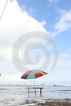 Beach umbrellas on the shore on a sunny day depict calm and solitude photo