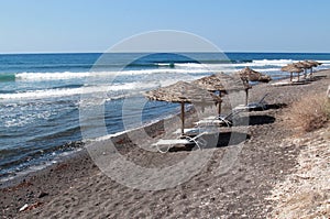 Beach umbrellas and sun beds, empty beach without people