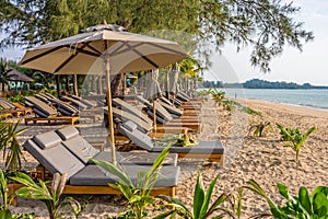 Beach umbrellas and sunbath seats on Pak Weep beach