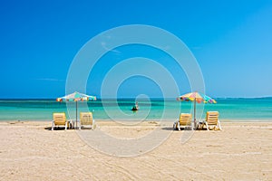 Beach umbrellas and sunbathe seats on Phuket sand beach