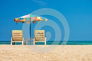 Beach umbrellas and sunbathe seats on Phuket sand beach