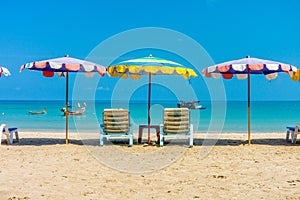 Beach umbrellas and sunbathe seats on Phuket sand beach