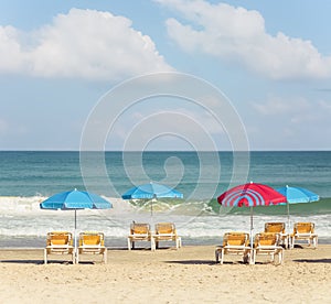 Beach umbrellas and sunbeds on the background of the sea
