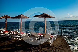 Beach umbrellas and sunbeds on the pontoon