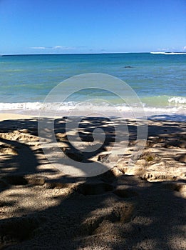 On the beach under shady tree at Kekaha Kai state park