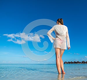 Beach vacation. Hot beautiful woman enjoying looking view of beach ocean on hot summer day.