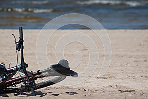 Beach view with bicycle on beach sand and sea in background