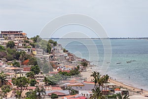 Beach view with fishermen and traditional Angolan boats, in Luanda beach, ghetto as background