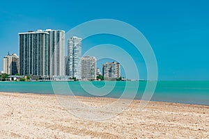 Beach view of the Skyline of Edgewater and Rogers Park with Lake Michigan in Chicago