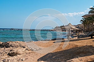 Beach vith umbrellas, palms. Red sea, Egypte.