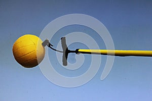 A beach volleyball being calibrated for the game photo