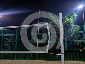 Beach volleyball court in the evening. Available infrastructure. Empty sports ground. Volleyball game concept. Sports mesh.