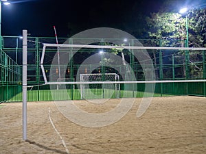 Beach volleyball court in the evening. Available infrastructure. Empty sports ground. Volleyball game concept. Sports mesh.