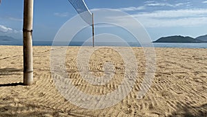 Beach volleyball court on the sandy shore near the sea. No one at the site.