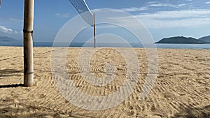 Beach volleyball court on the sandy shore near the sea. Sea view, sunny day