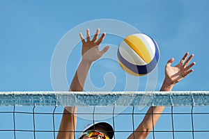 Beach volleyball player jumps