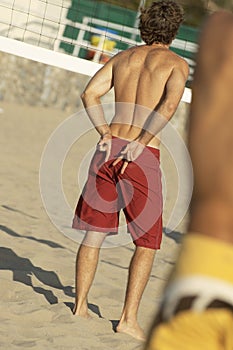 Beach volleyball player signalling team-mate