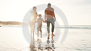 Beach, walking and boy holding hands with parents for adventure, fun or bonding together. Happy, sunset and child or kid