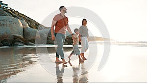 Beach, walking and child holding hands with parents for adventure, fun or bonding together. Happy, sunset and boy kid