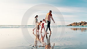 Beach, walking and family holding hands, summer and happiness with weekend break and travel. Parents, mother and father