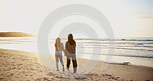 Beach, walking and mother holding hands with kid at sunset on travel vacation, holiday or weekend trip. Happy, love and