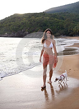 Beach, walking and portrait of woman with dog on tropical vacation, adventure or holiday. Happy, travel and young female